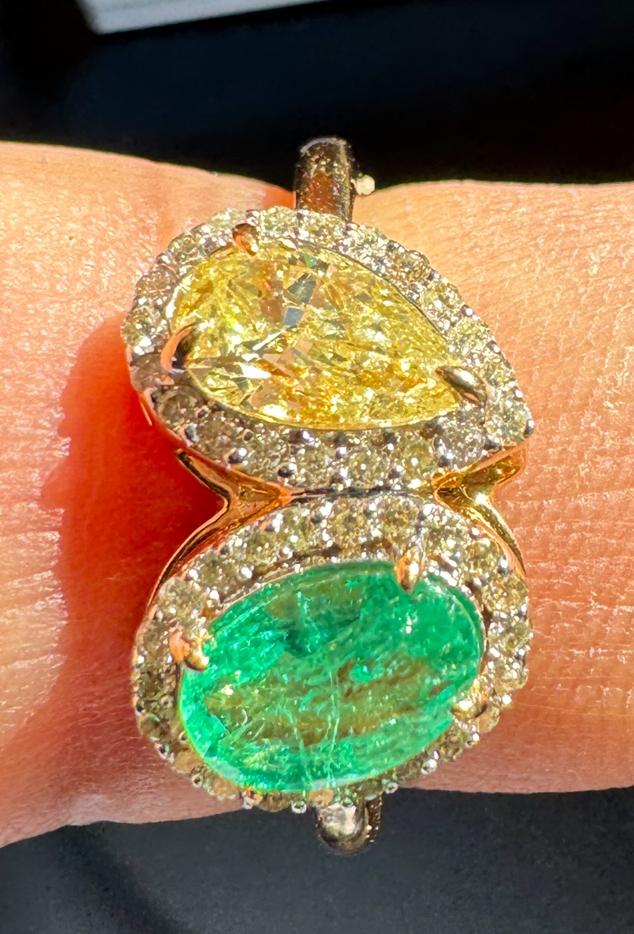 18K Gold ring with fancy yellow Diamond and Columbian Emerald on a finger